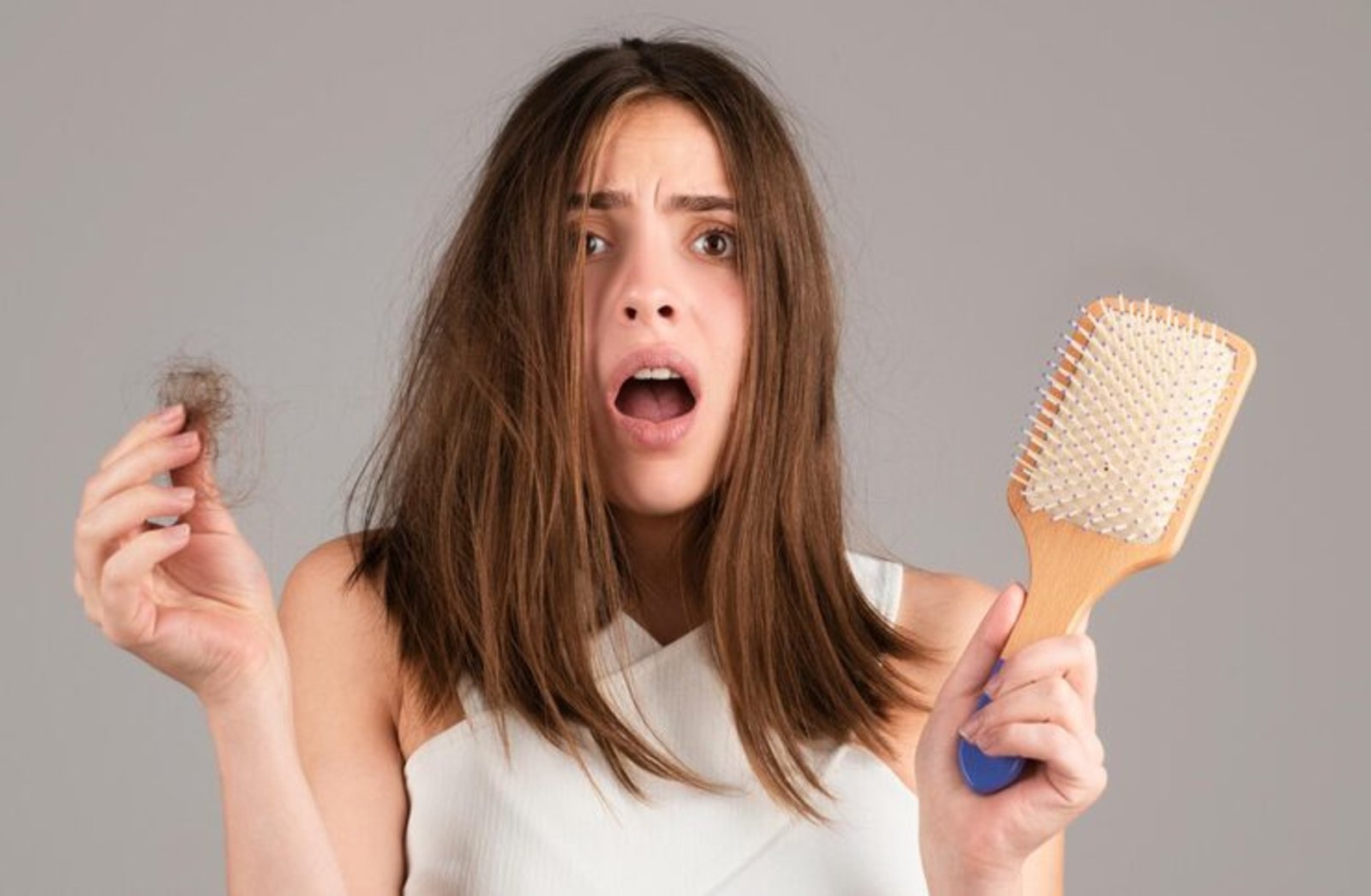 hair-loss-woman-is-upset-hair-loss-portrait-sad-girl-with-problem-hair-isolated-worried-girl-holding-long-damaged-unhealthy-hair-hand_265223-165094_QHD_2560px